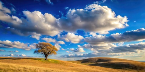 Serene Landscape Featuring a Solitary Tree on Rolling Hills Under a Dramatic Sky
