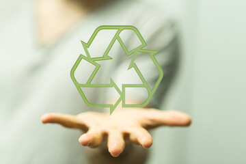 Image of a hand holding a recycling symbol.  Perfect for eco-friendly, sustainability, and...