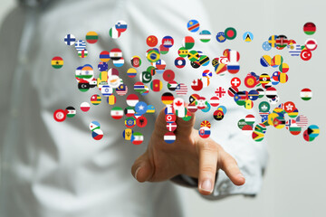 Abstract image of a hand interacting with floating flags representing global connections and international business.