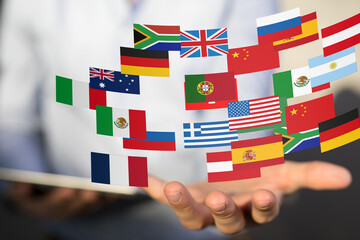 Image of diverse national flags held in a hand, symbolizing global business, international...