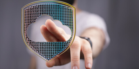 Image of a hand interacting with a digital shield protecting cloud data.  Ideal for cybersecurity...