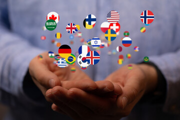 Image of hands holding many flags representing global business, international trade and cooperation.