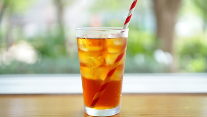 Refreshing Iced Tea with Straw on Wooden Table
