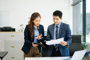 Kind leader executive manager share and discuss business solutions plan ideas on tablet with Asian...