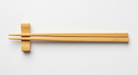 Photo Of Wooden Chopsticks Resting on Chopstick Holder Against White Background