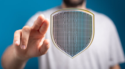 Hand interacting with a digital shield, symbolizing cybersecurity and data protection.