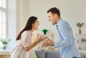Couple woman and man arguing and shouting at each other, have quarrel and problems in relationship, want to divorce, gesturing angrily, having misunderstanding. Family quarreling concept