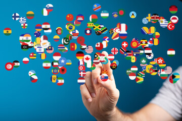 Image of a hand interacting with floating flags representing global connectivity and international...