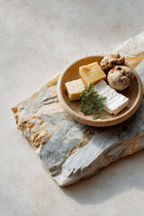 Assorted Cheeses with Cookies on Rustic Stone Plate