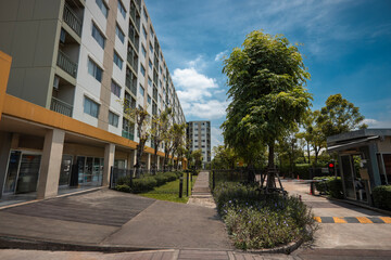 Modern Apartment Complex with Security Gate and Green Landscape in Urban Area