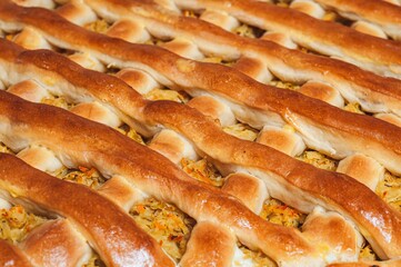 A detailed view of a freshly baked lattice pie, showcasing the golden-brown crust and savory filling.
