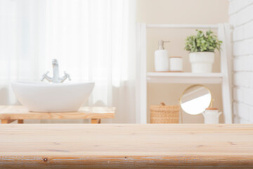 Bleached wood table top for product montage on blurred bathroom window and shelf interior background