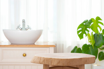 Round wooden side table as pedestal for product display montage on blur bathroom sink interior background