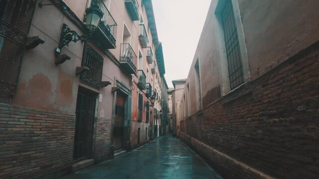 Moody narrow old alleyway in city center of Zaragoza. Spain. Daytime. C. de la Pabostr&iacute;a, Casco Antiguo behind Cathedral of the Savior of Zaragoza