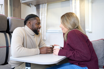 Obraz premium Couple talking at table in motorhome