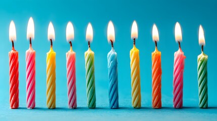 Colorful birthday candles with vibrant flames in a row, symbolizing joy and celebration