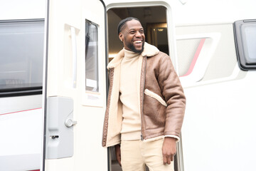 Smiling man getting off motorhome