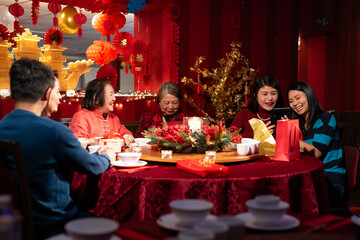 Smiling family celebrating Chinese New Year in restaurant