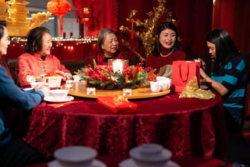 Smiling family celebrating Chinese New Year in restaurant