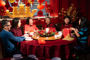 Smiling family celebrating Chinese New Year in restaurant
