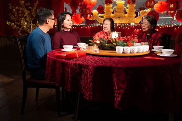 Smiling family celebrating Chinese New Year in restaurant