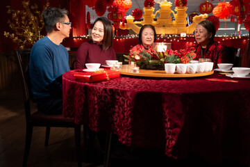 Smiling family celebrating Chinese New Year in restaurant