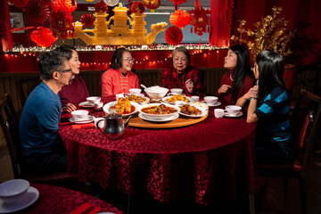 Smiling family enjoying Chinese New Year dinner in restaurant