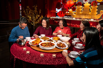 Smiling family enjoying Chinese New Year dinner in restaurant