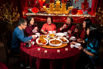 Smiling family enjoying Chinese New Year dinner in restaurant