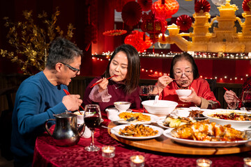Family enjoying Chinese New Year dinner in restaurant