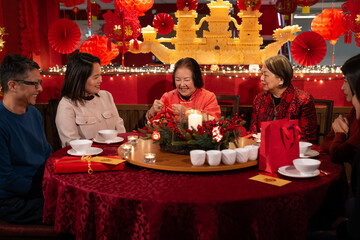 Smiling family celebrating Chinese New Year in restaurant