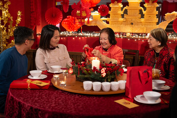 Smiling family celebrating Chinese New Year in restaurant