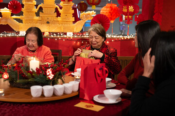 Smiling women celebrating Chinese New Year in restaurant