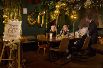 People celebrating 60th birthday at nightclub