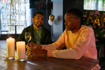 Friends enjoying drinks at table during New Years Eve party