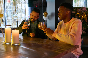 Friends enjoying drinks at table during New Years Eve party