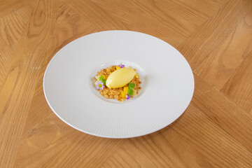 Mango Sorbet with Crumble and Edible Flowers on White Plate