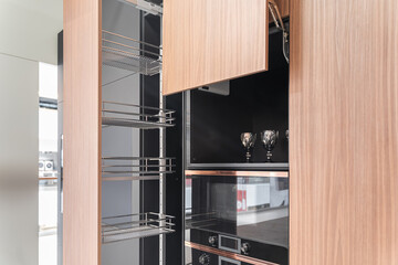 modern huge built-in kitchen with upper and lower cabinets, shelves, drawers. wooden and gray...