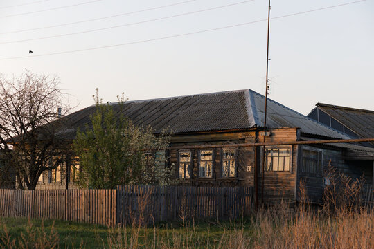 A house with a wooden fence and a roof
