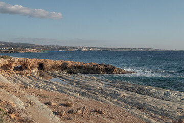 Geological landscape on Mediterranean sea coastline in sunny day. Sea caves, cliffs and arches landscape in Cyprus. White stones cave cliff rocks 