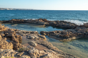 Geological landscape on Mediterranean sea coastline in sunny day. Sea caves, cliffs and arches landscape in Cyprus. White stones cave cliff rocks 