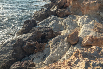 Geological landscape on Mediterranean sea coastline in sunny day. Sea caves, cliffs and arches landscape in Cyprus. White stones cave cliff rocks 