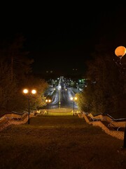 A street with a sidewalk and a staircase