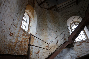 A staircase in a building with a window above it