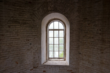 A window in a building with a brick wall