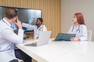 medical team discussing and review rare disease case to improve the practice guidelines,multiracial orthopedic doctors working in medical conference room