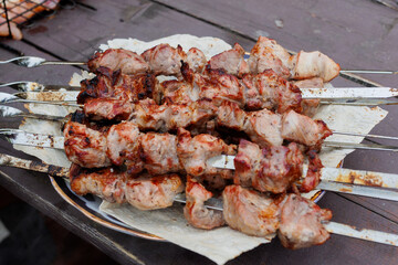 Top down close up of boneless, skinless chicken thighs being grilled.