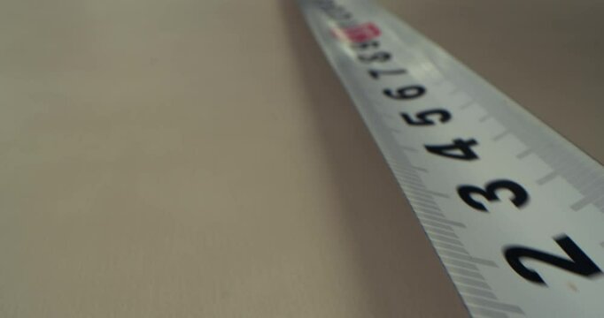 Tape measure close-up. The measuring tape macro, camera moves up, shooting with slider.