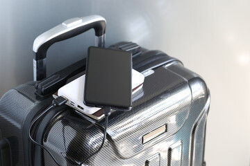Power bank and passport on luggage for travel of holiday