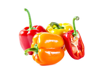 Mix of colorful whole and sliced ​​bell peppers. Isolated on white background.